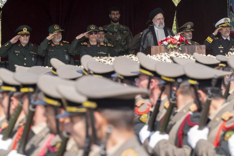 イラン軍の兵士とハーメネイー師（写真／AFP＝時事）