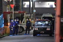 発砲事件現場に残されたタクシー（右手前）。2024年5月30日午前、埼玉県川口市（時事通信フォト）